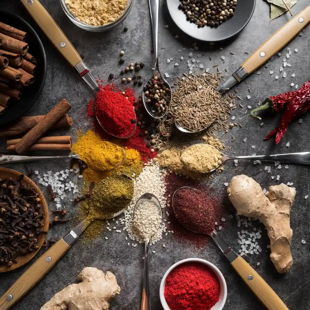 Mauritius masala and assorted Mauritius spices arranged in spoons, showcasing authentic blends available at Mauritian Food Online