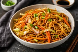 A savory bowl of dry stir-fry vegetable noodles made with authentic Apollo Noodles UK, tossed with crisp shredded carrots, cabbage, and spring onions.