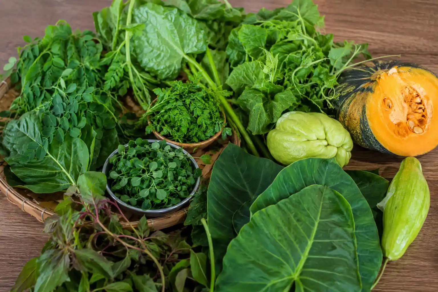 Authentic Mauritian vegetables UK including brèdes, taro leaves, moringa, chayote and pumpkin displayed fresh for traditional cooking